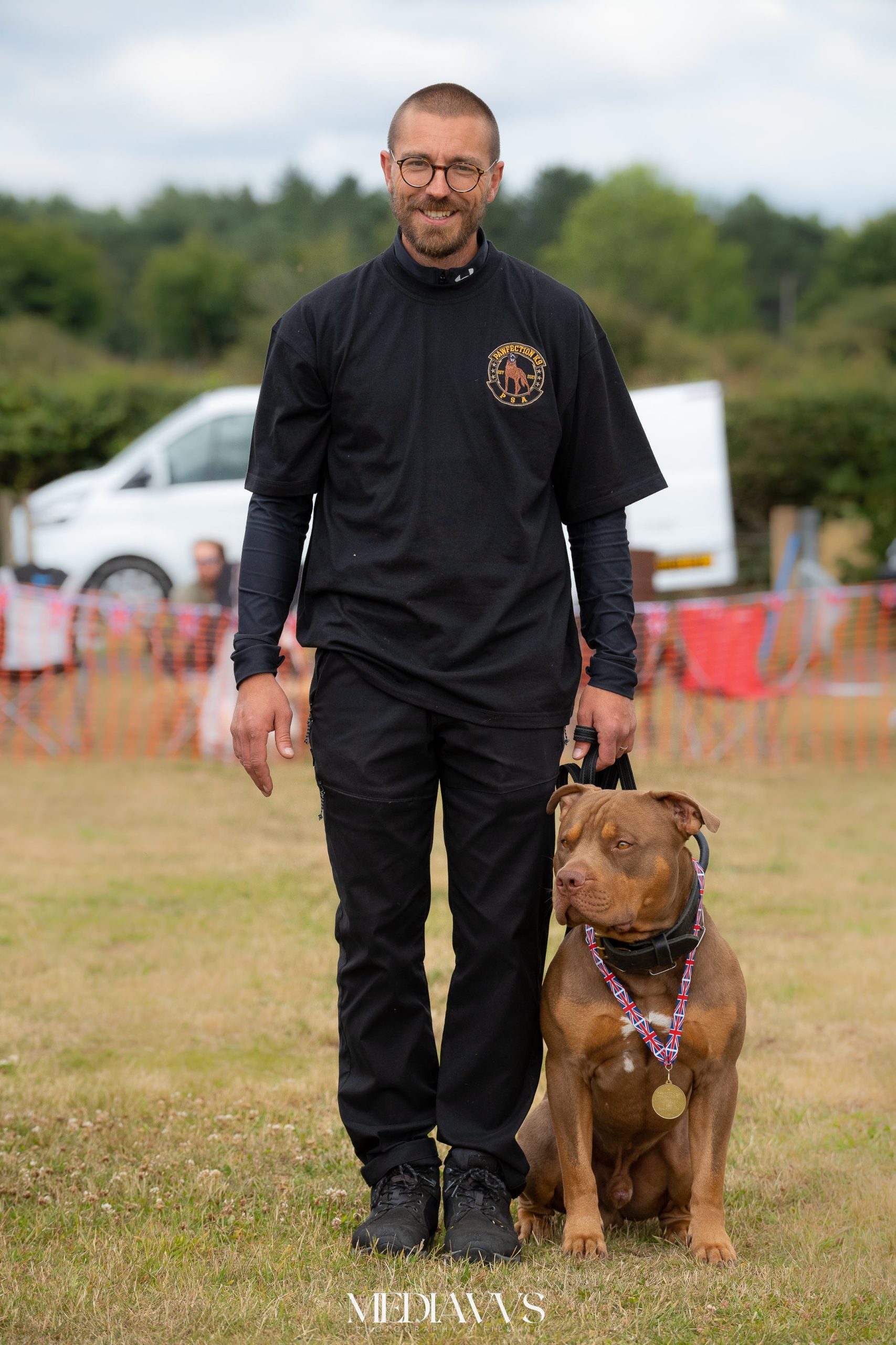<p>Professional dog trainer Chris Halls with his XL bully Odin, who has won awards in PSA competitions </p>